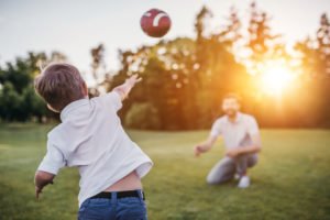 Vater spielt mit dem Kind Ball 